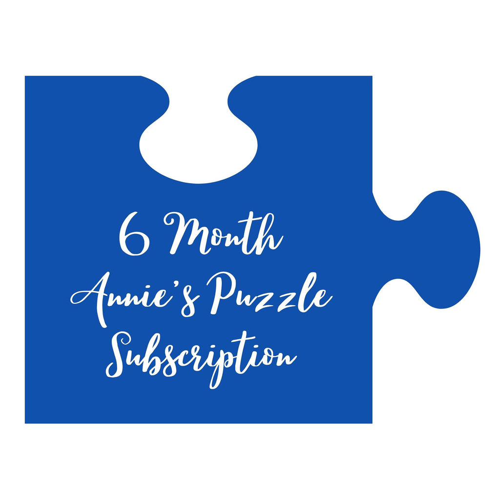 An illustration of a blue puzzle piece with "6 month annie's puzzle subscription" in white lettering.