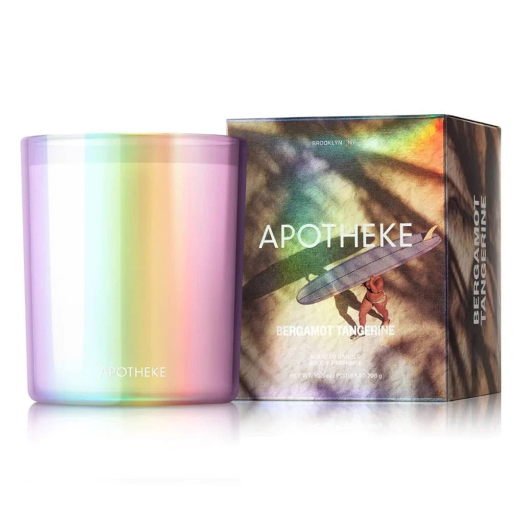 Apotheke x League Creative Co. 10 ounce Bergamot Tangerine scented soy wax blend candle in translucent iridescent glass vessel with illustrated gift box, front view.