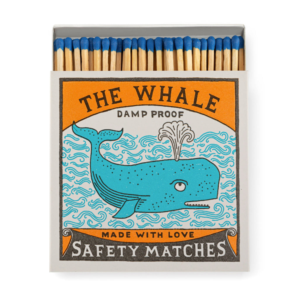 Archivist Gallery The Whale square match box with blue and orange whale illustration, slid open slightly to see blue-tipped wood 4 inch matches inside.