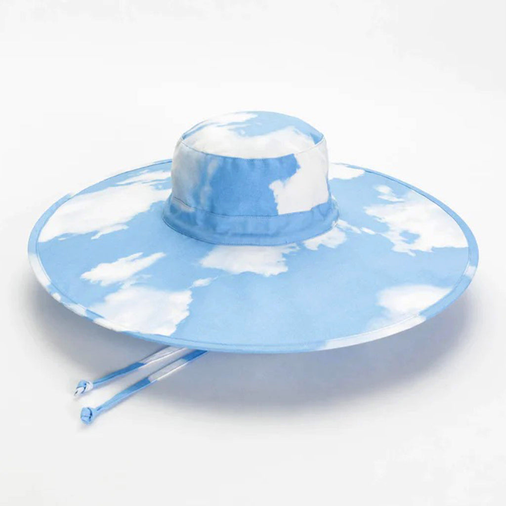 Baggu Clouds print cotton packable sun hat top view, open with chin straps peeking out from underneath.