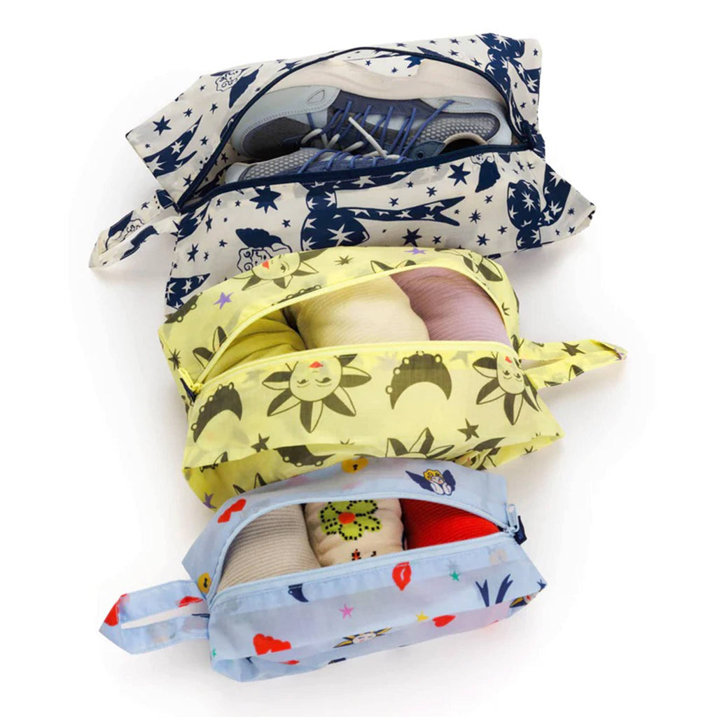 Baggu reusable recycled ripstop nylon 3D zip bags, set of 3 in charms print collection, zipper open and filled with shoes and clothing.