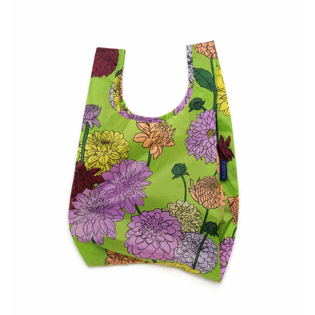 Baggu baby size eco-friendly recycled ripstop nylon reusable tote bag with the Dahlia print on a green background, unfolded.