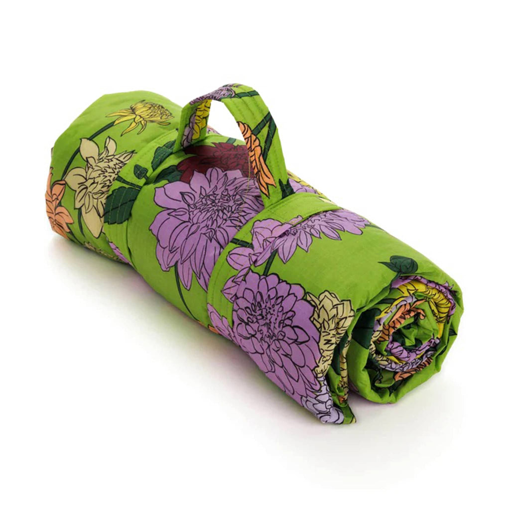 Baggu dahlia puffy recycled ripstop nylon and polyester picnic blanket, rolled up with strap.