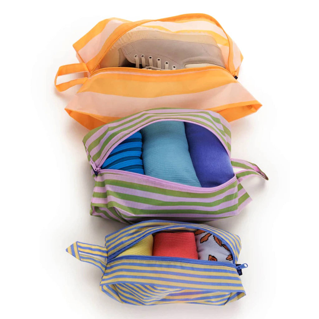 Baggu reusable recycled ripstop nylon 3D zip bags, set of 3 in Hotel Stripe prints, unzipped and filled with shoes and clothing.