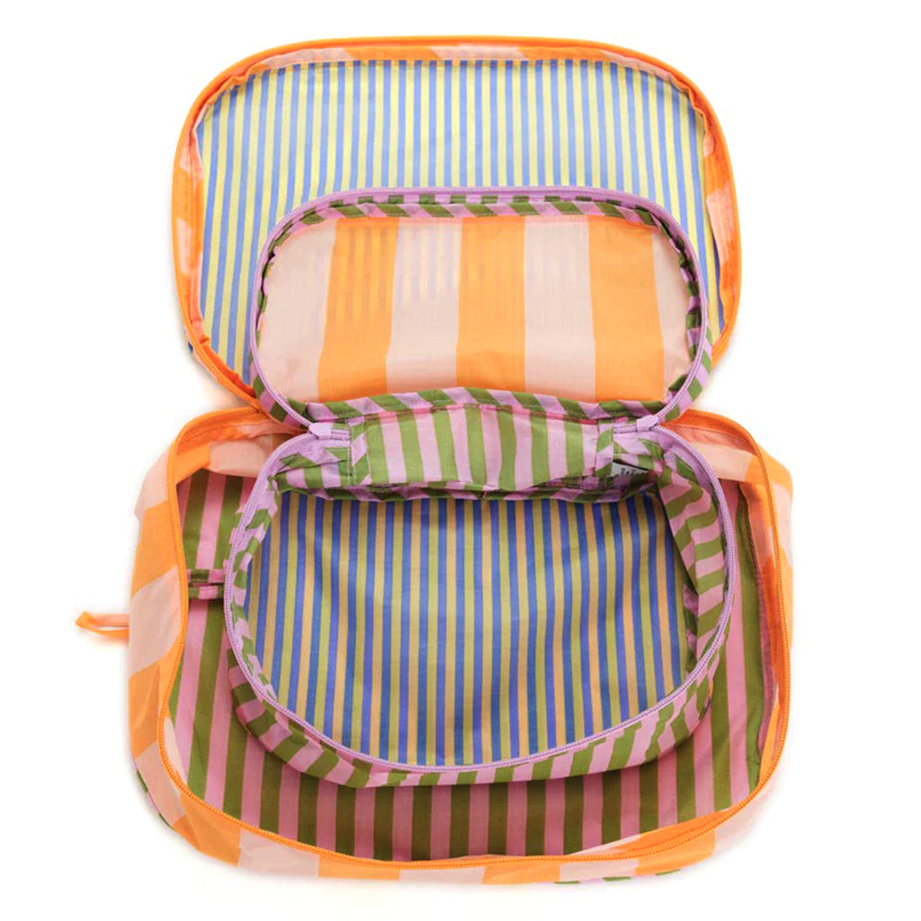 Baggu reusable recycled ripstop nylon packing cube set of 2, both sizes have the colorful hotel stripes prints, unzipped and nested.