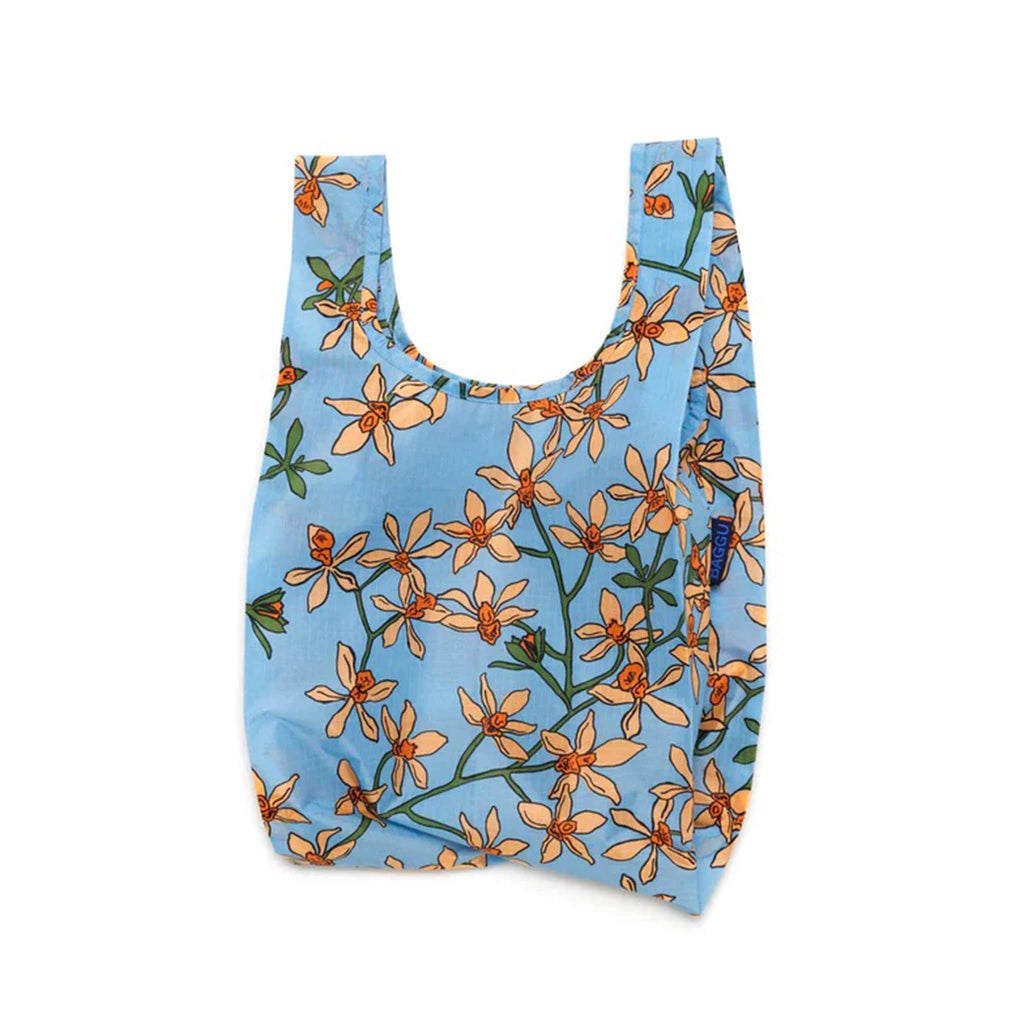 Baggu baby size eco-friendly recycled ripstop nylon reusable tote bag with the orange Orchid print on a medium blue background, unfolded.