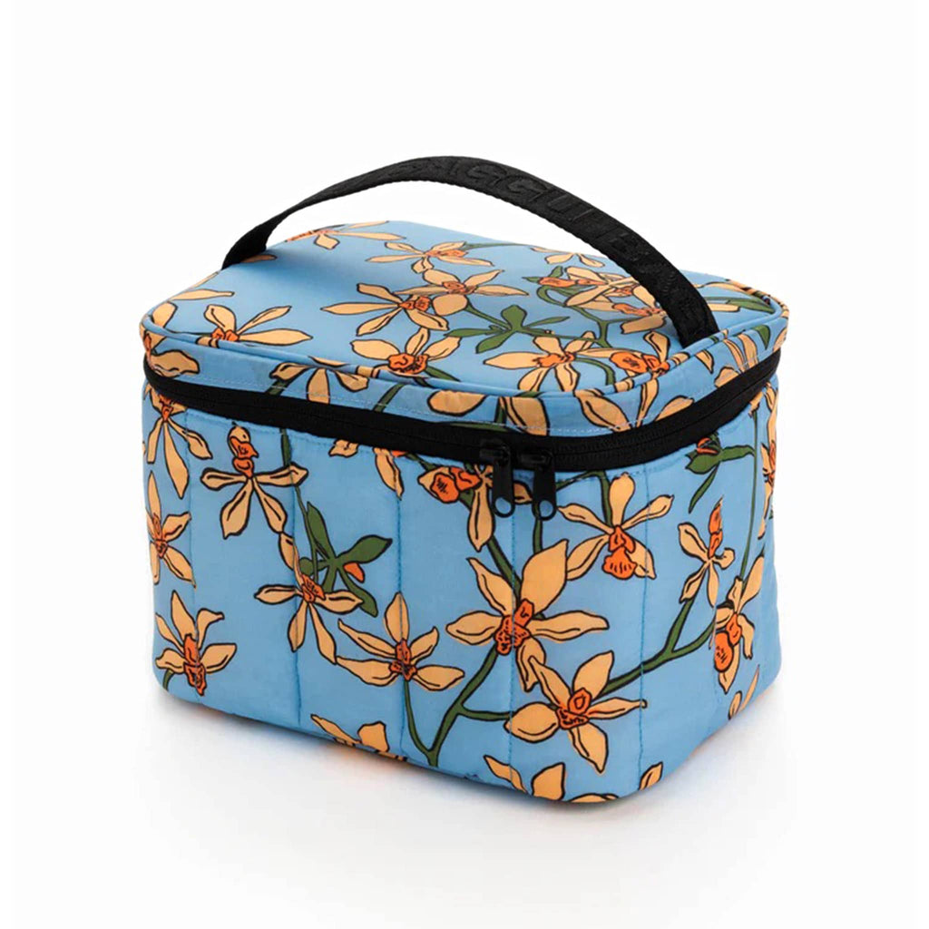 Baggu Insulated Puffy Lunch Bag with orange orchids on a blue backdrop print and a black zipper and handle, front view.