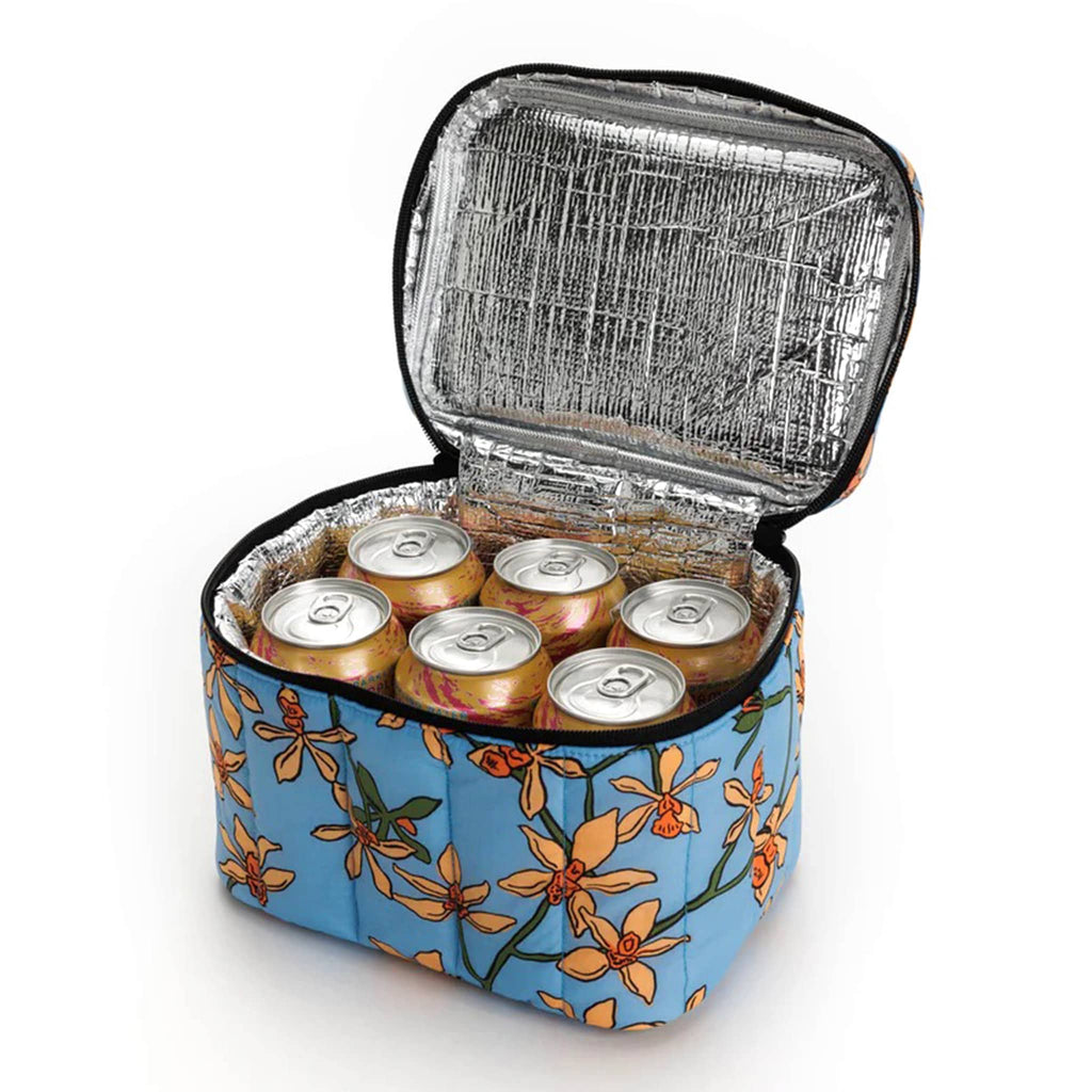 Baggu Insulated Puffy Lunch Bag with orange orchids on a blue backdrop print and a black zipper and handle, front view, lid open with a six pack of cans inside.