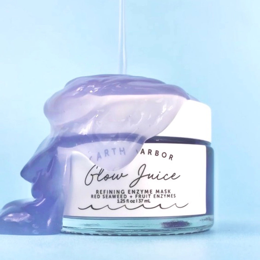 Earth Harbor Glow Juice Refining Enzyme Mask in glass jar with a pour of the purple colored gel mask over it.