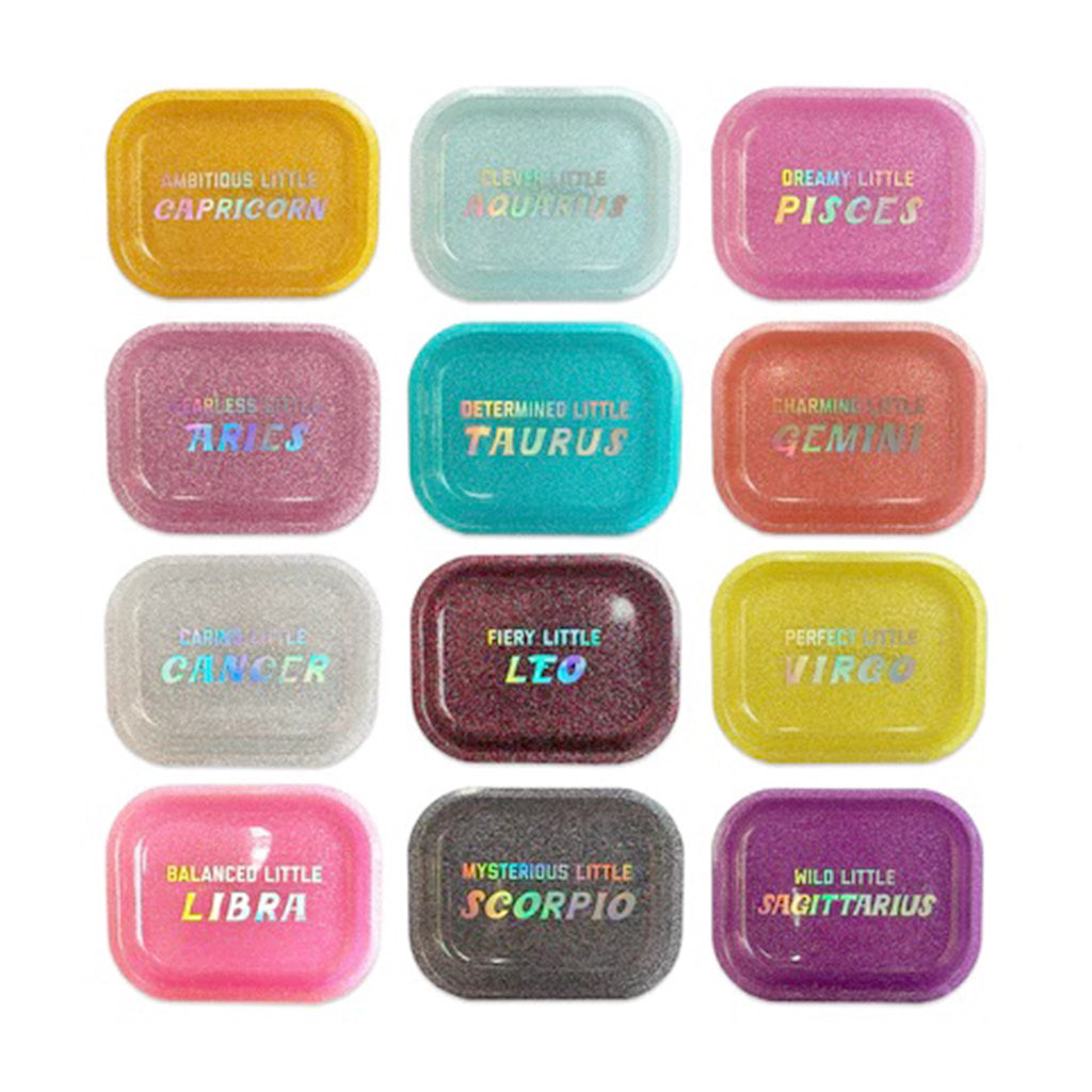 Golden Gems acrylic glitter trays in assorted colors, each with an astrological sign and trait printed in iridescent white embossing.