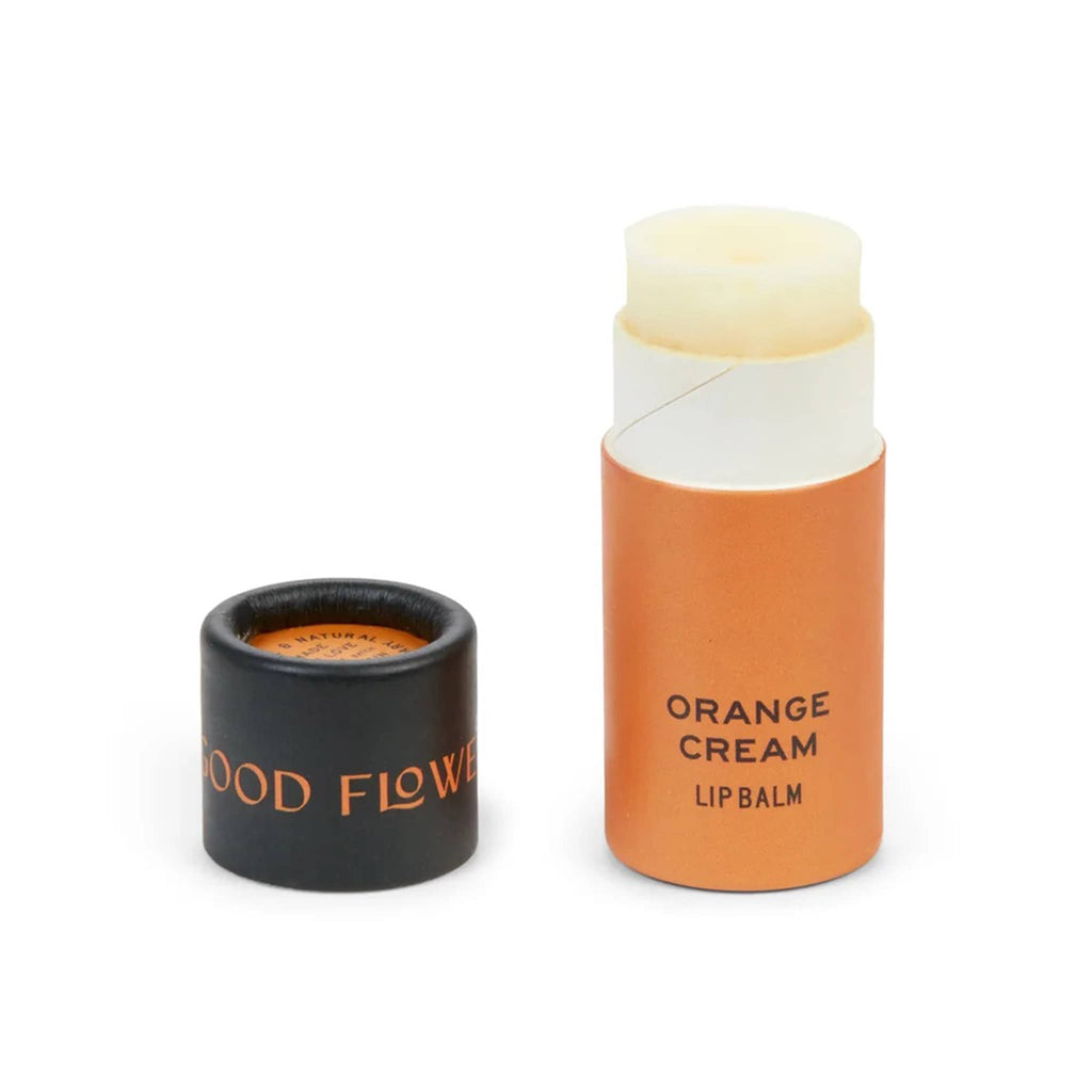 Good Flower Farm Orange Cream scented lip balm in orange paper tube packaging with lid off.