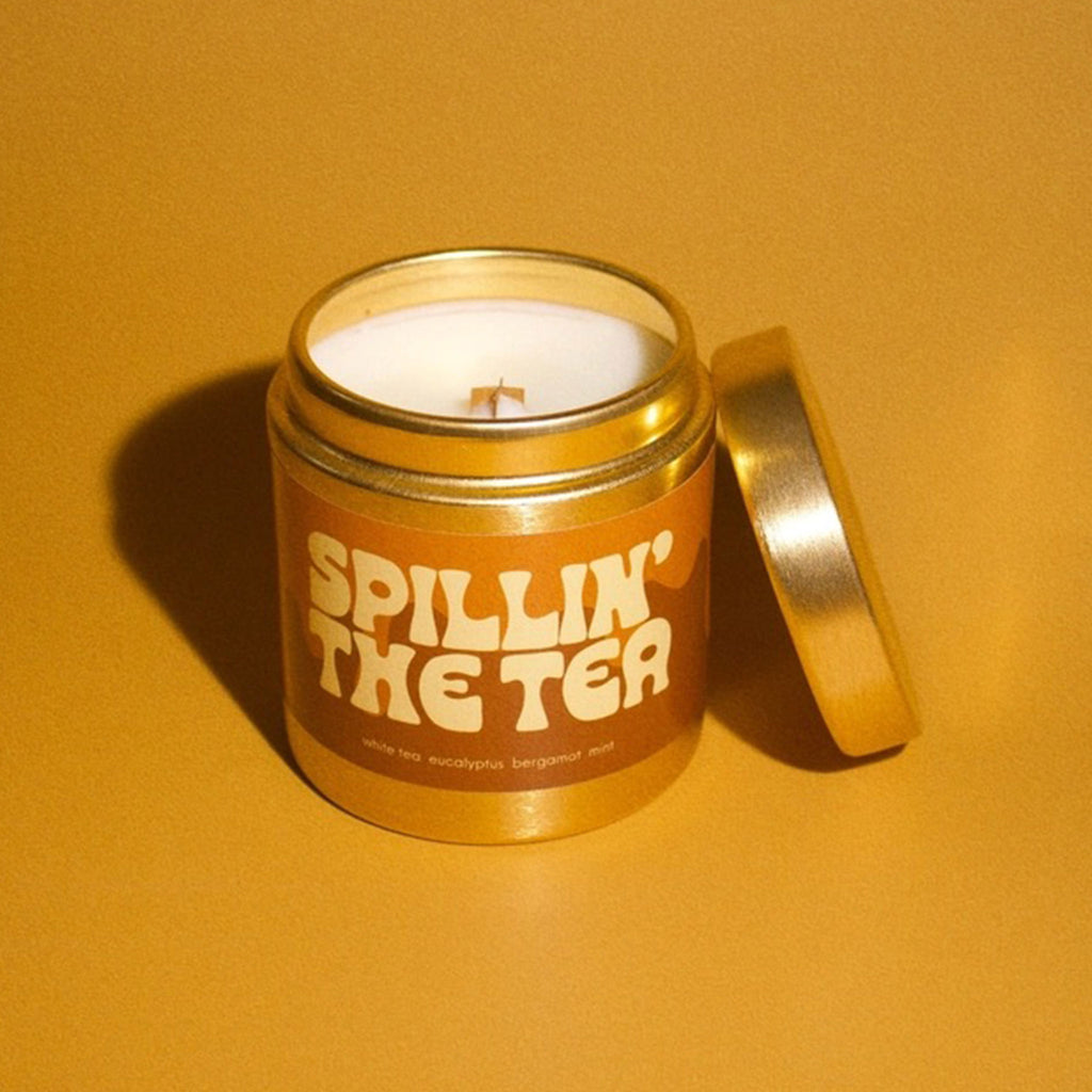 Lightened Candle Co. Spillin' The Tea coconut wax blend scented candle with notes of white tea, eucalyptus, bergamot and mint in a brushed gold tin with wood wick.