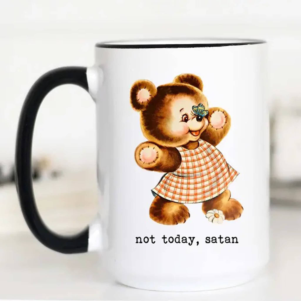 Mugsby white ceramic mug with black handle and rim with a vintage-inspired illustration of a wearing a dress with a butterfly on its nose and "not today, satan" in black lettering.