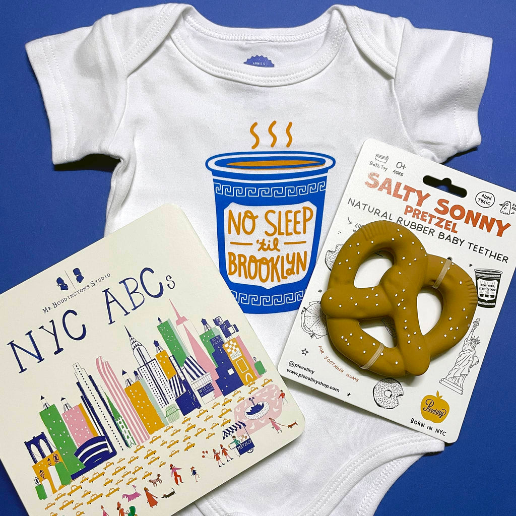 ABRGS NYC Baby Bundle with "No Sleep 'til Brooklyn" baby one-piece, Salty Sonny Pretzel Teether and NYC ABC's board book.