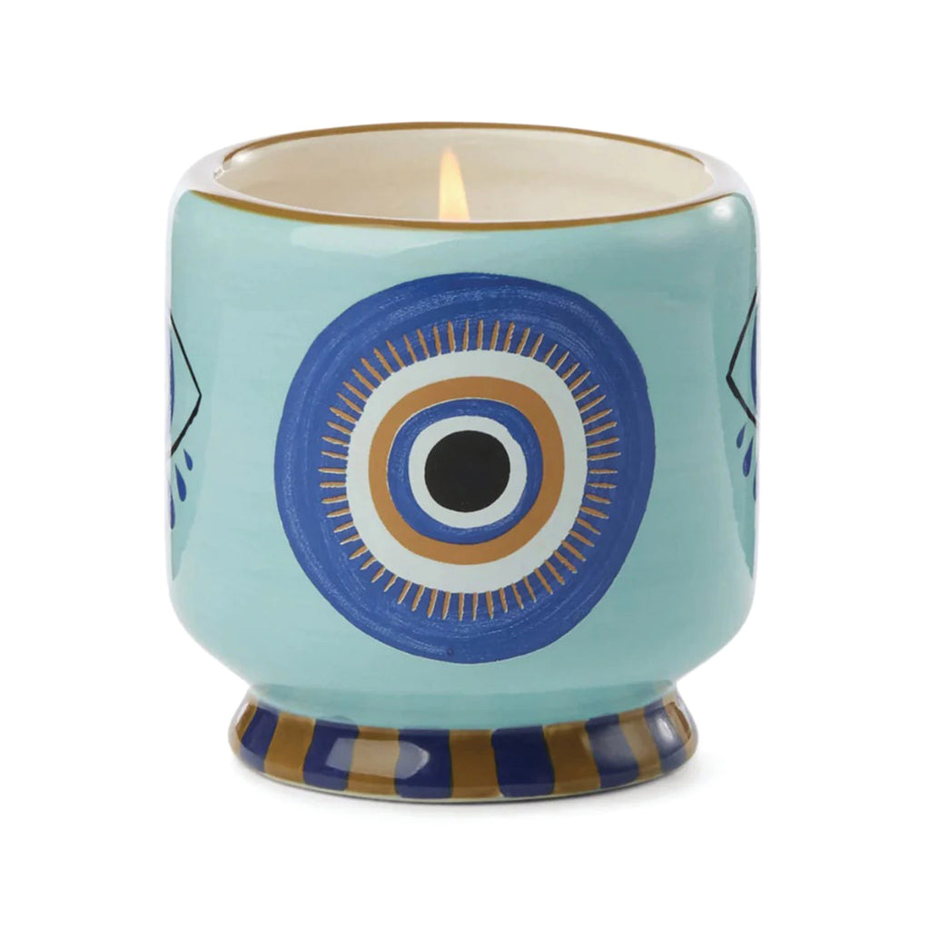 Paddywax A Dopo 8 ounce Incense and Smoke scented candle in a ceramic vessel hand painted with an eye design.