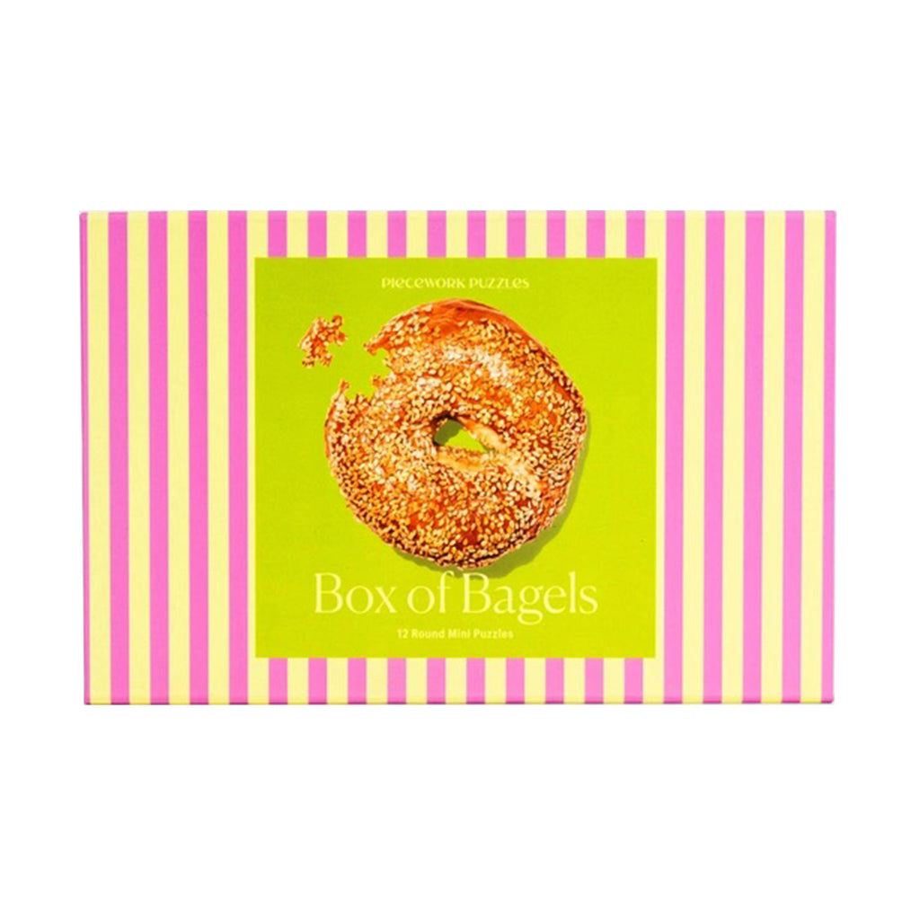 Piecework Puzzles Box of Bagels, set of 12 round mini puzzles in pink and lime green striped box packaging.