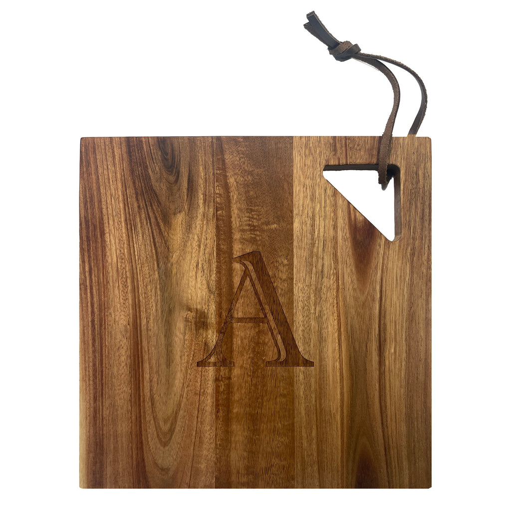 Maple Leaf at Home 9x9 acacia wood modern square serving board with handle cutout and engraved monogram, front view.