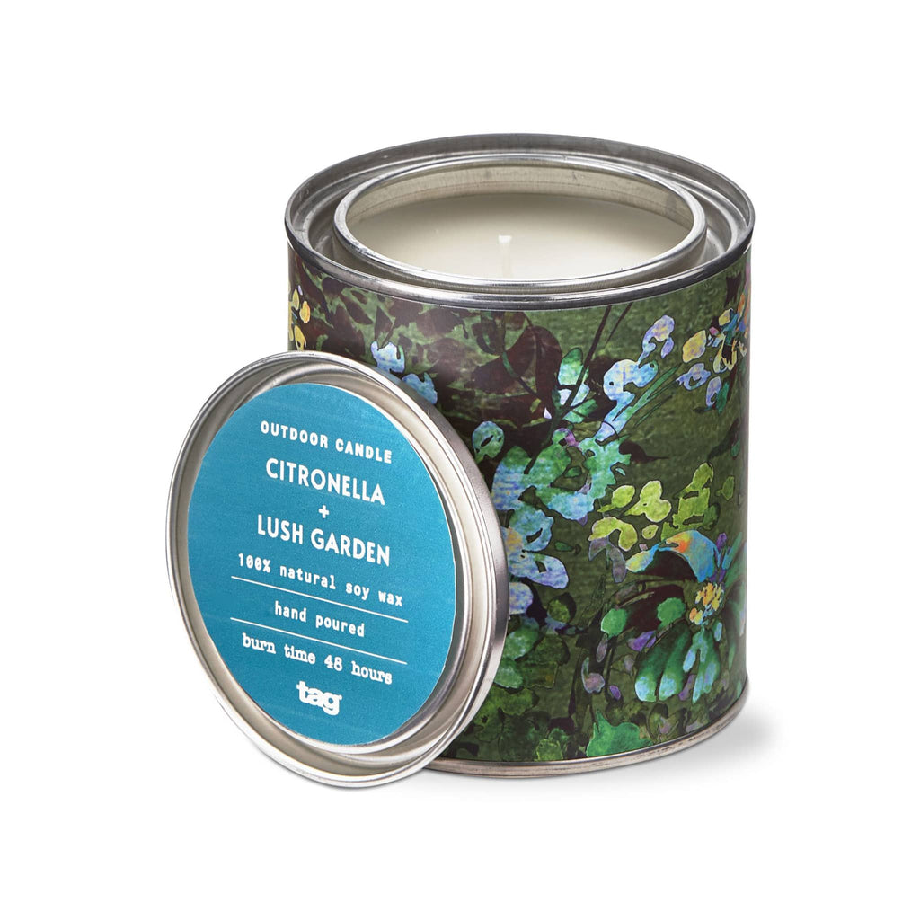 Tag Limited Citronella and Lush Garden scented soy wax candle in tin with abstract green botanical print, lid off.