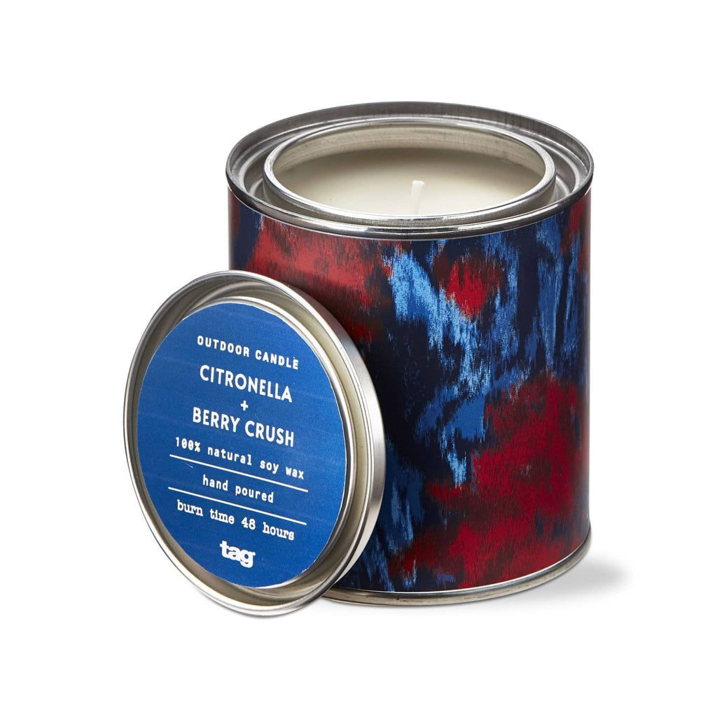 Tag Limited Citronella and Berry Crush scented soy wax candle in tin with abstract red and blue print, lid off.