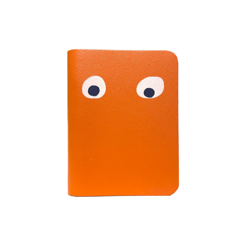 Ark Colour Design Googly Eye Mini Notebook with orange leather cover, front view.