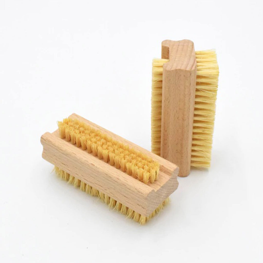 earth & nest double-sided nail brushes with untreated beechwood handle and plant-based fiber bristles, one laying down, one standing upright to show bristle length on both sides