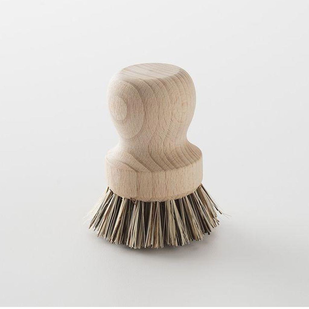 earth & nest pot and pan hand brush with unfinished wood handle and plant-based fiber bristles facing down