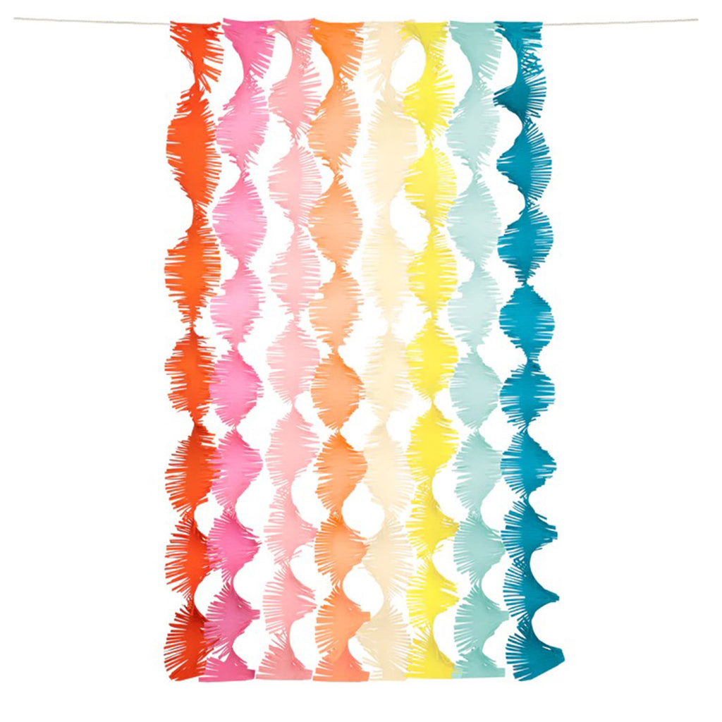 Meri Meri Rainbow Twisty Fringe Backdrop Garland made with colorful streamers hanging on a natural color cord.