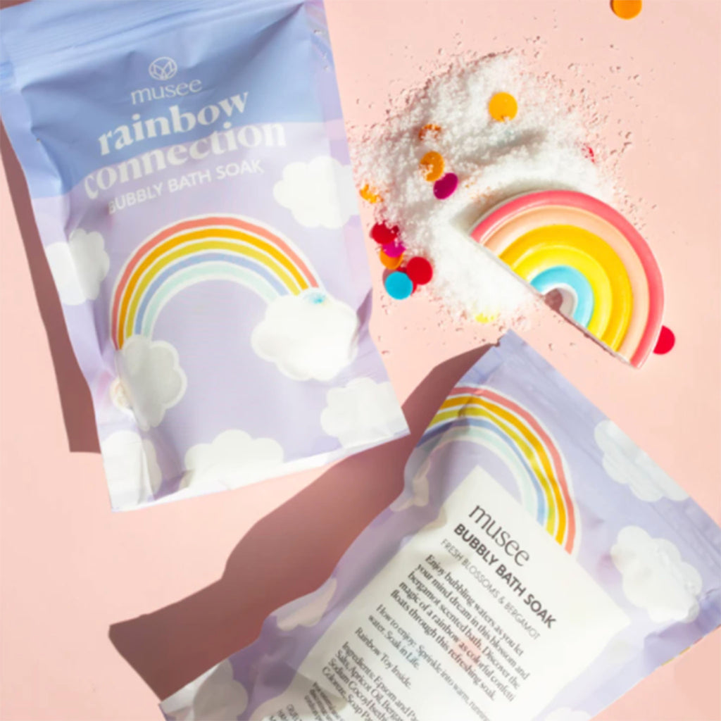 musee rainbow connection scented bubbly bath soak in packaging front and back with soak spill and surprise