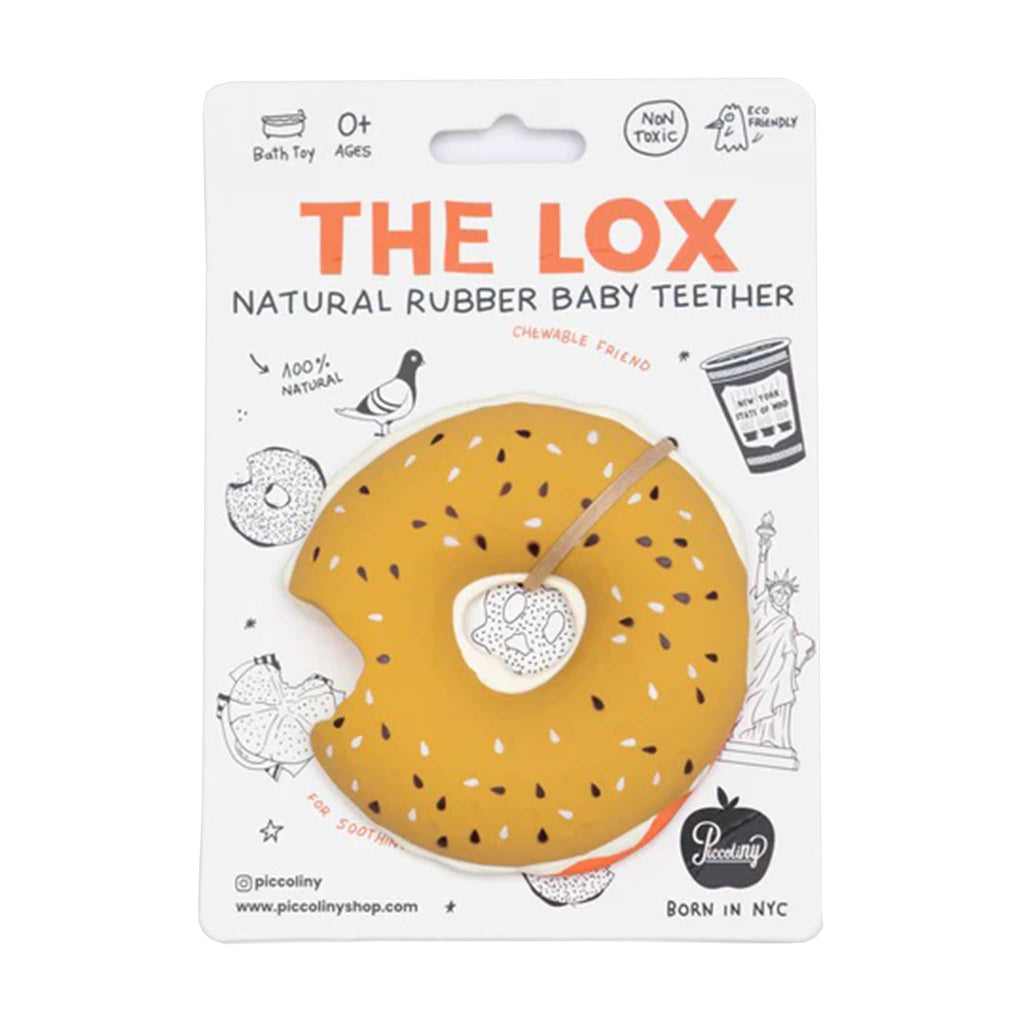 Everything bagel with lox and cream cheese shaped natural rubber baby teether bath toy on card packaging.