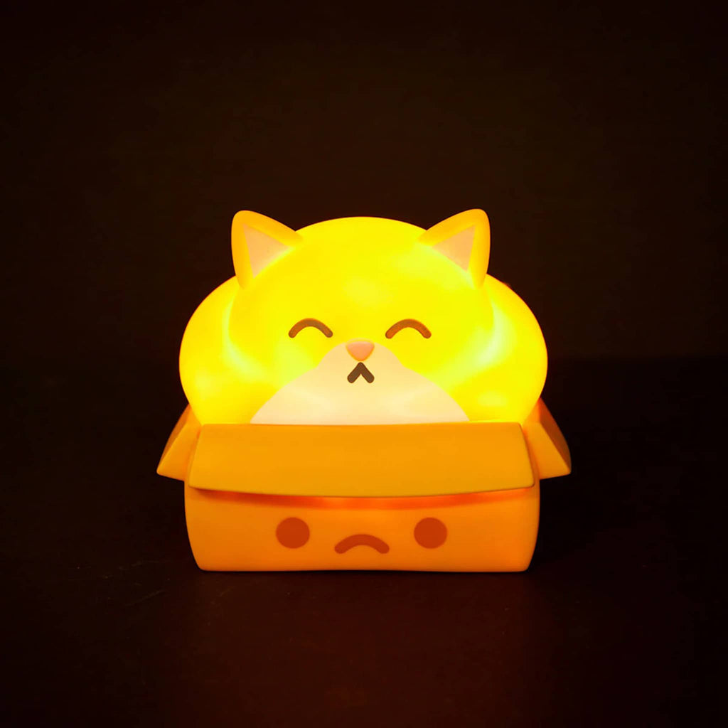 Glowing yellow cat-shaped night light on a black background.