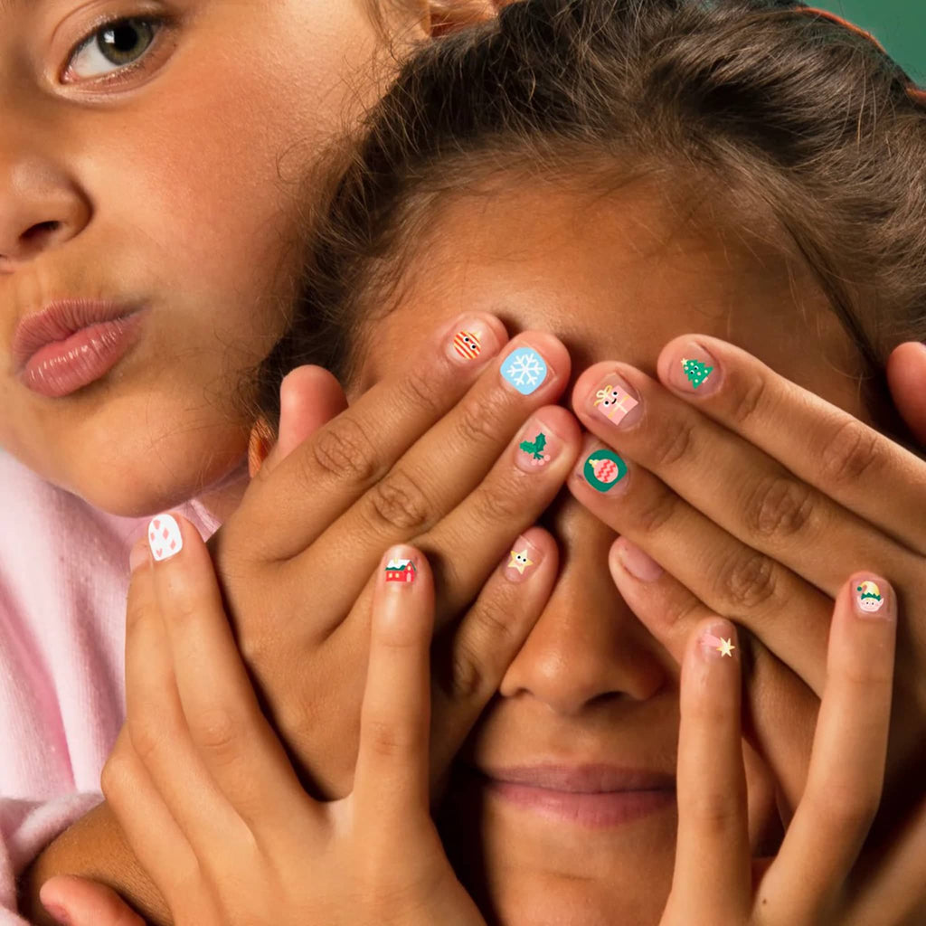 Two children with decorated nails covering one another's eyes.