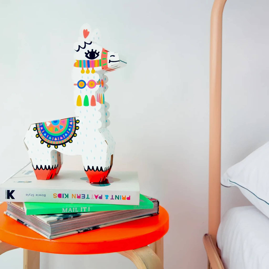 OMY Llama 3D Lamp DIY kit, completed lamp on bedside stool with books.