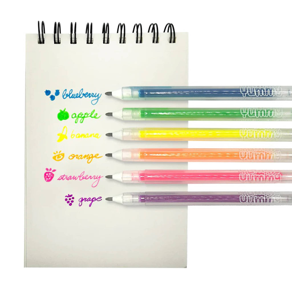 Ooly Yummy Yummy fruit scented neon gel pens, set of six with color swatches and scent written out on a pocket notebook.