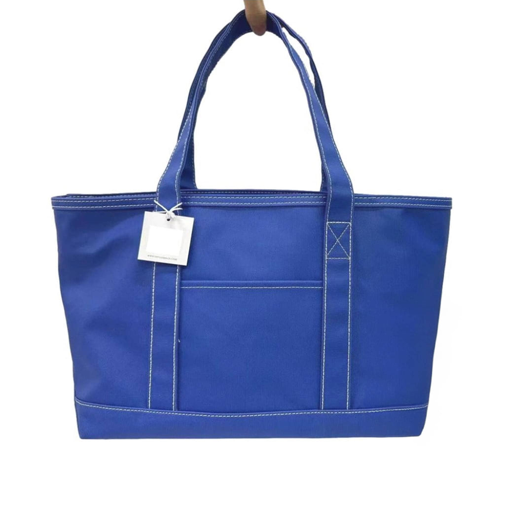 TRVL medium blue bell coated cotton canvas tote bag, front view.