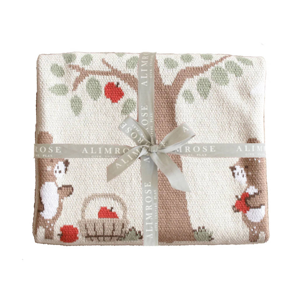 Alimrose Teddy Bear Picnic cotton baby blanket folded up and tied with a logo ribbon.