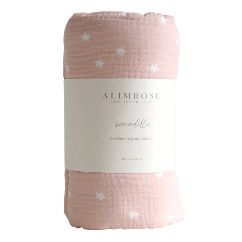 Alimrose Starry Night Petal Pink organic cotton muslin baby swaddle, rolled up with bellyband packaging.