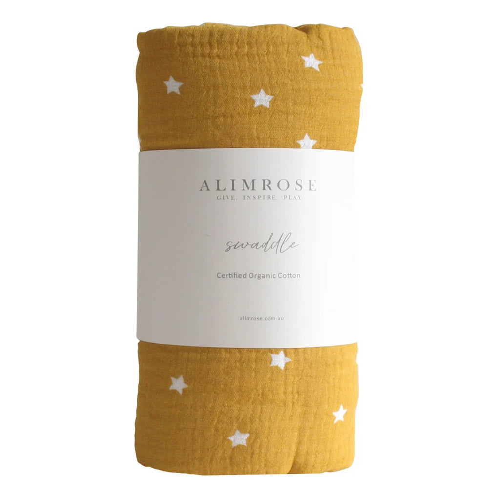 Alimrose Starry Night Butterscotch organic cotton muslin baby swaddle, rolled up with bellyband packaging.