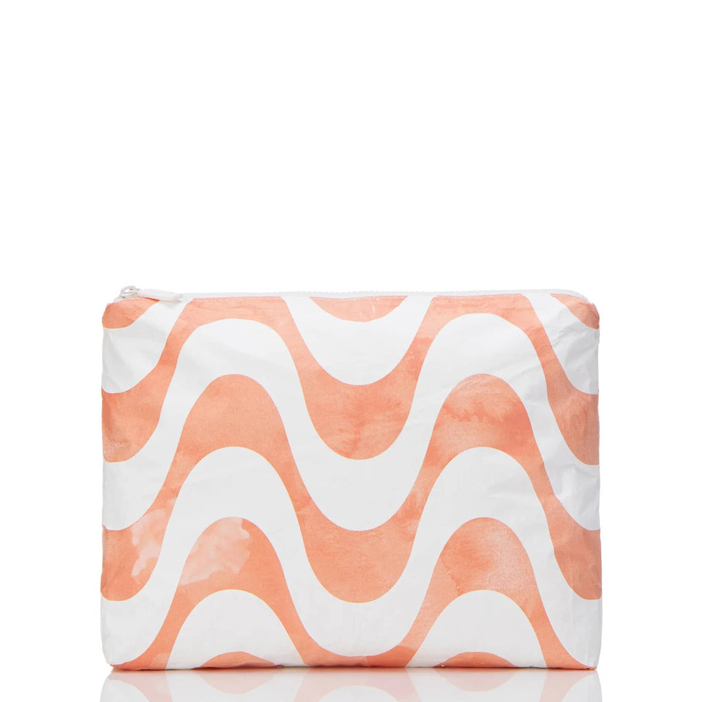 Aloha Collection Coral Splash Calcada medium splash-proof zip pouch with pale orange and white horizontal wave pattern, front view.