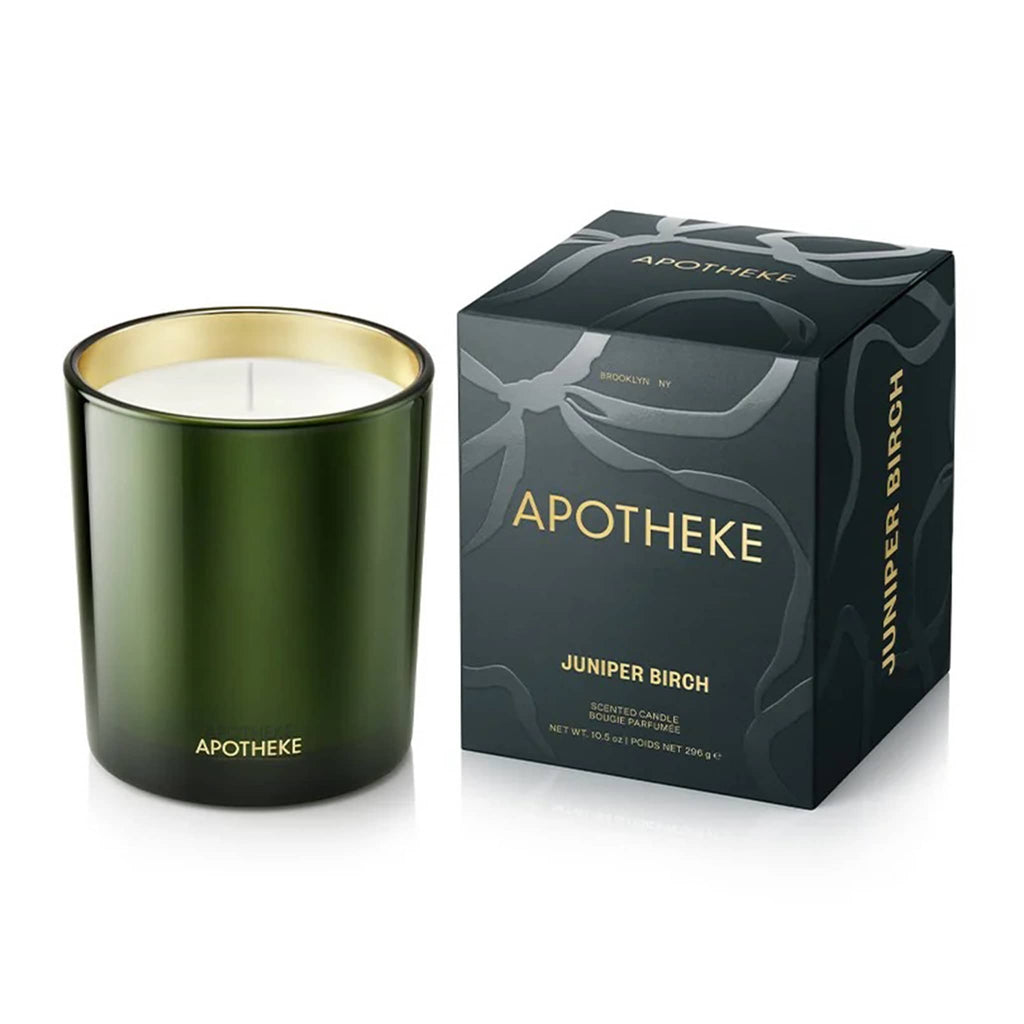 Dark green candle with gold rim and matching box labeled 'Apotheke Juniper Birch' on a white background.