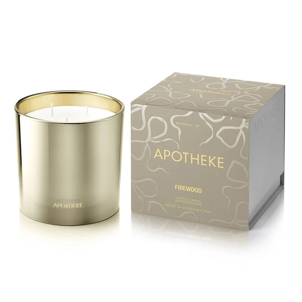 Apotheke Firewood scented 3-wick candle in beige metallic vessel and matching packaging on a white background.