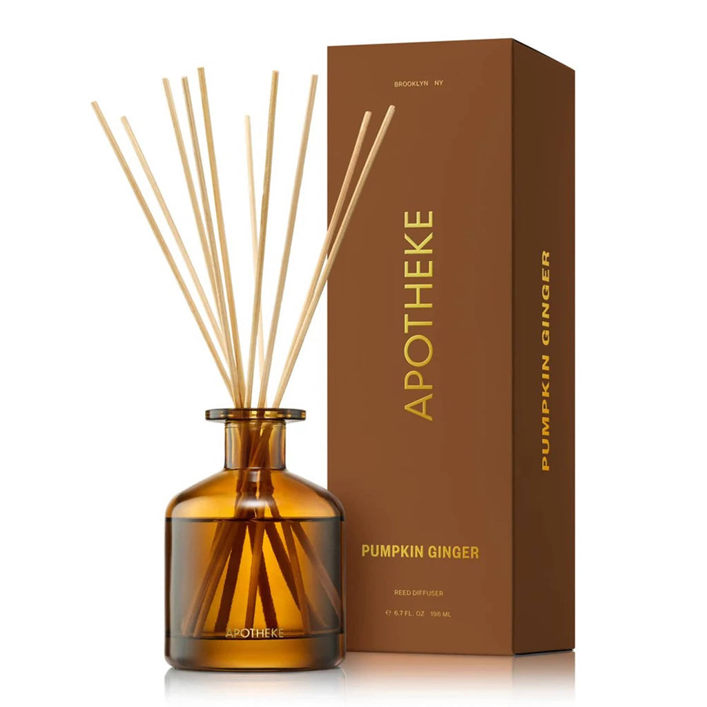 Apotheke 6.7 ounce Pumpkin Ginger scented reed diffuser with sticks in bronze glass bottle next to matching gift box with gold lettering.