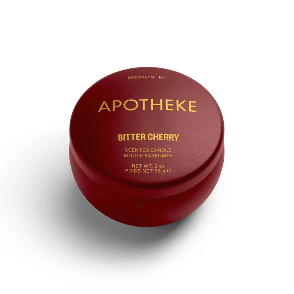 Apotheke 2 ounce Bitter Cherry scented soy wax blend candle in deep cherry red metal mini tin with lid on.