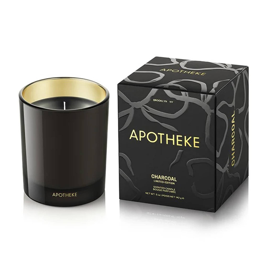 Black candle with gold interior and matching packaging box on a white background.