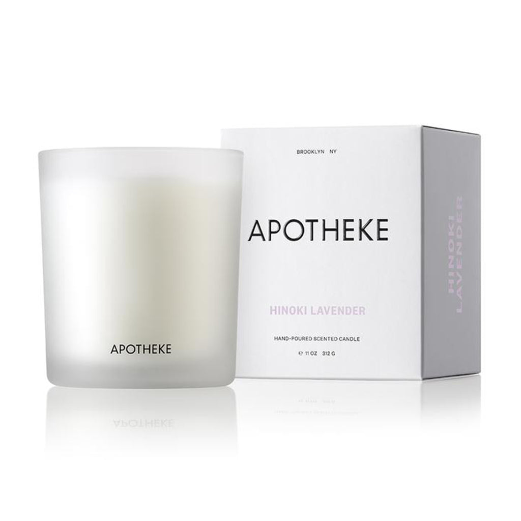Apricot Hinoki Lavender scented candle from Apotheke in translucent white glass vessel with white gift box that has black and lilac lettering.