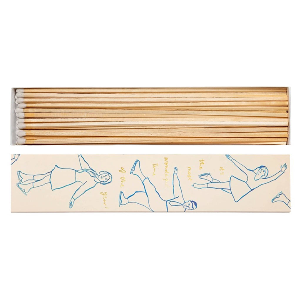 Set of long wooden matches in a decorative box featuring illustrations of ice skaters in blue, on a white background.