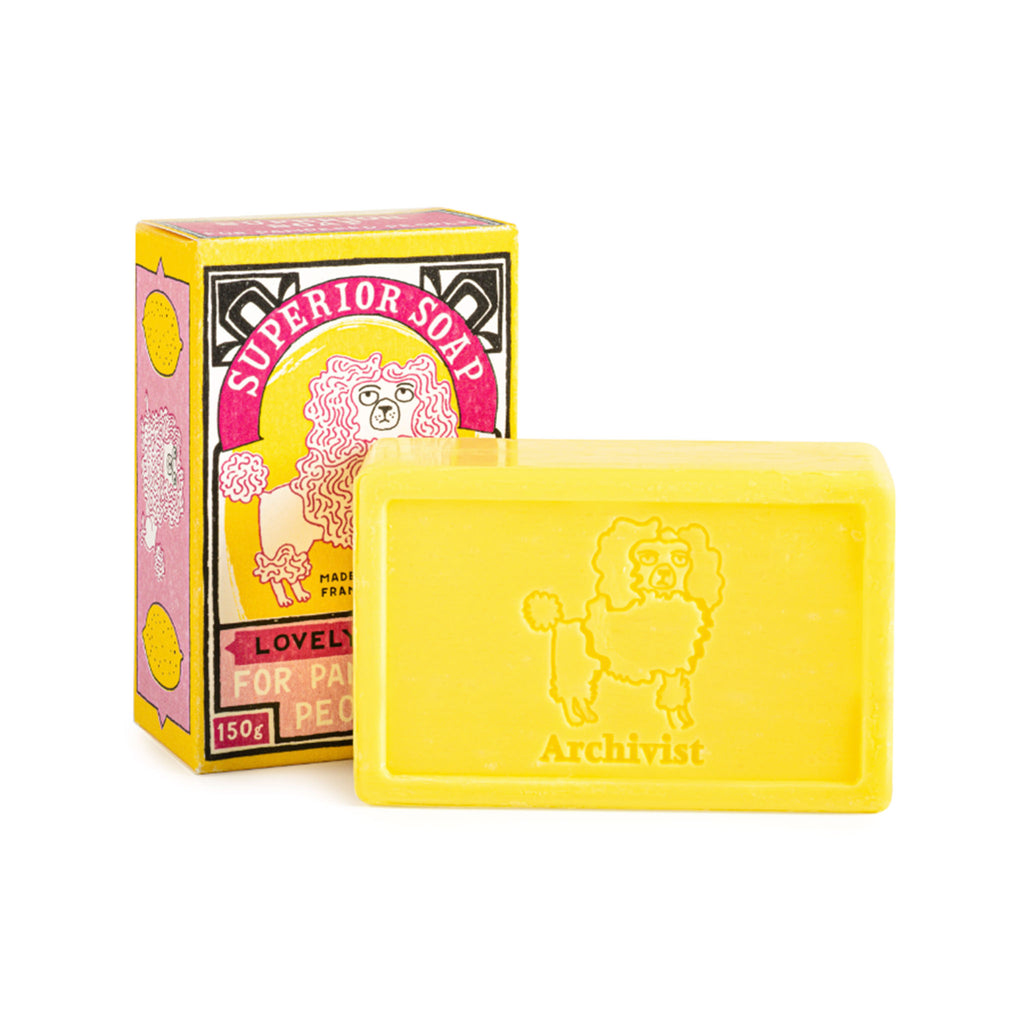 Archivist Gallery Lemon Scented yellow bar soap with yellow box packaging with a pink poodle illustration.