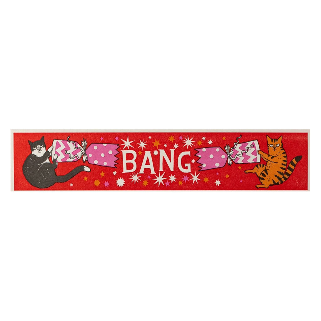 Red matchbox with cartoon cats and the word 'BANG' on a white background.