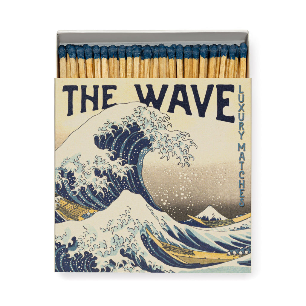 Archivist Gallery square match box with Hokusai's The Wave artwork on the front, slightly open showing wooden matches with blue tips inside.