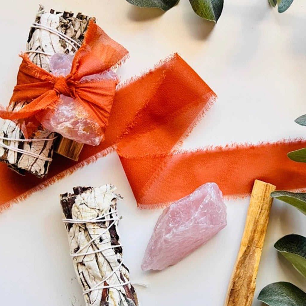 Ark Made Rose Quartz crystal, Palo Santo and Yerba Santa smudge bundle with orange chiffon ribbon.