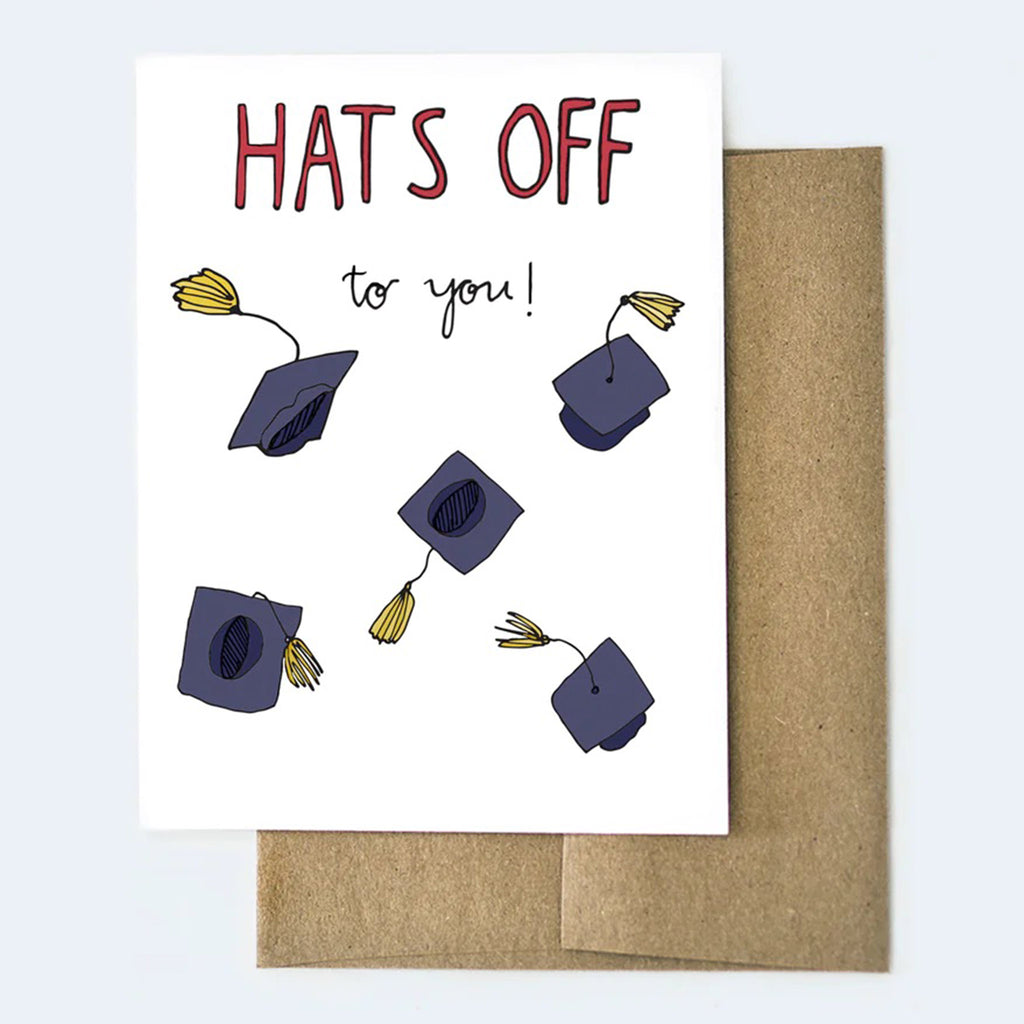 Aviate Press graduation greeting card with "Hats off to you" and illustrations of caps and tassels flying in the air with a kraft envelope behind.